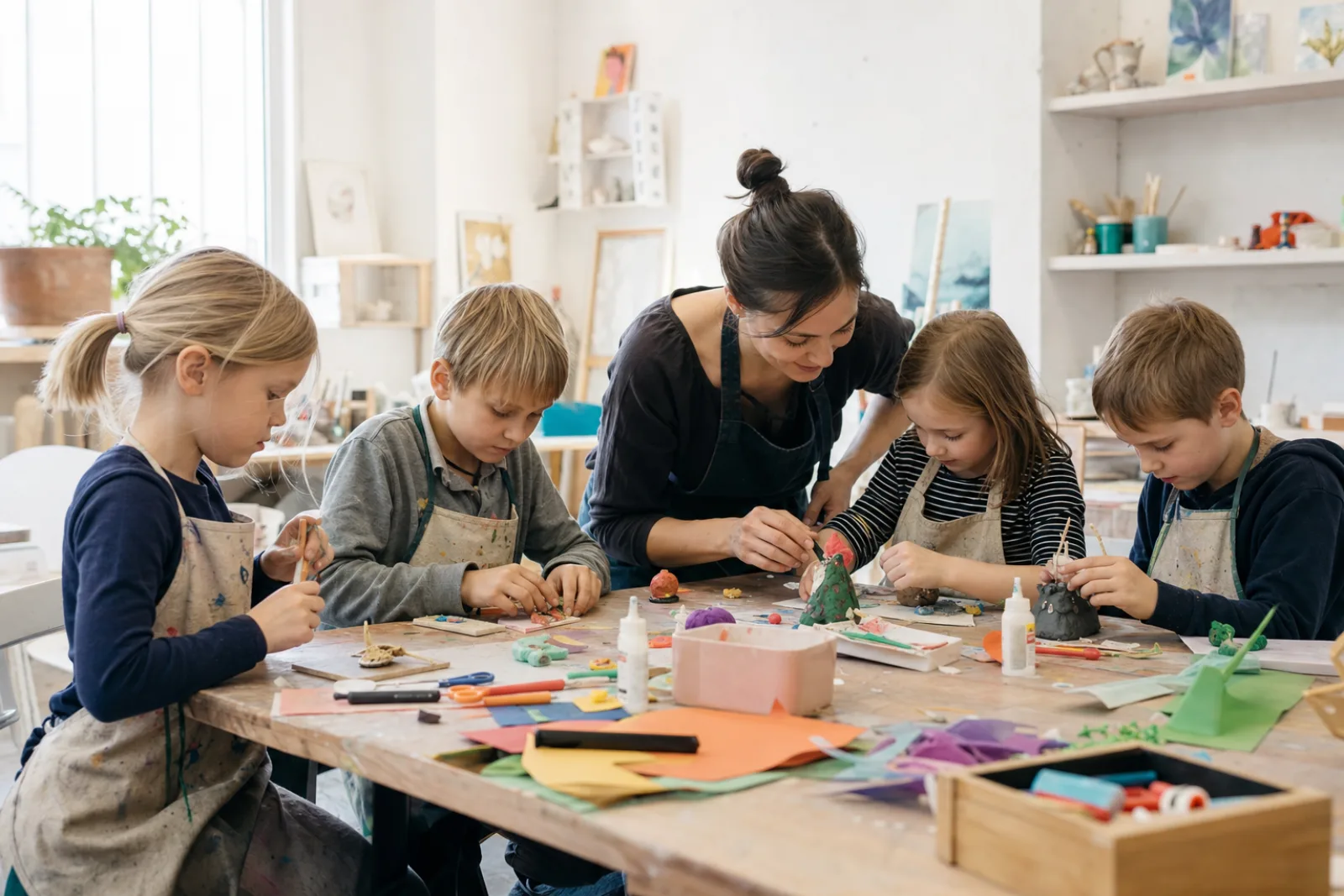 Children make crafts together with an instructor in a bright workshop.